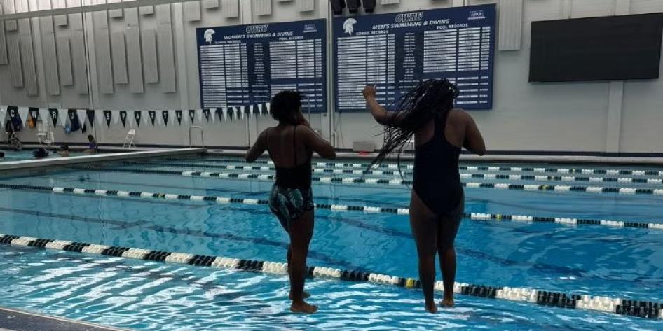 Two kids jumping in a pool