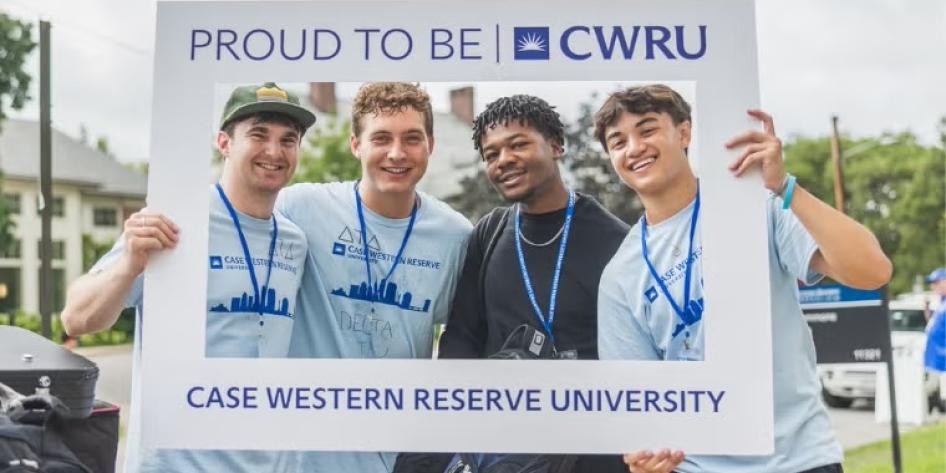 CWRU students smile with a "PROUD TO BE CWRU" picture frame during move-in on Aug. 17.