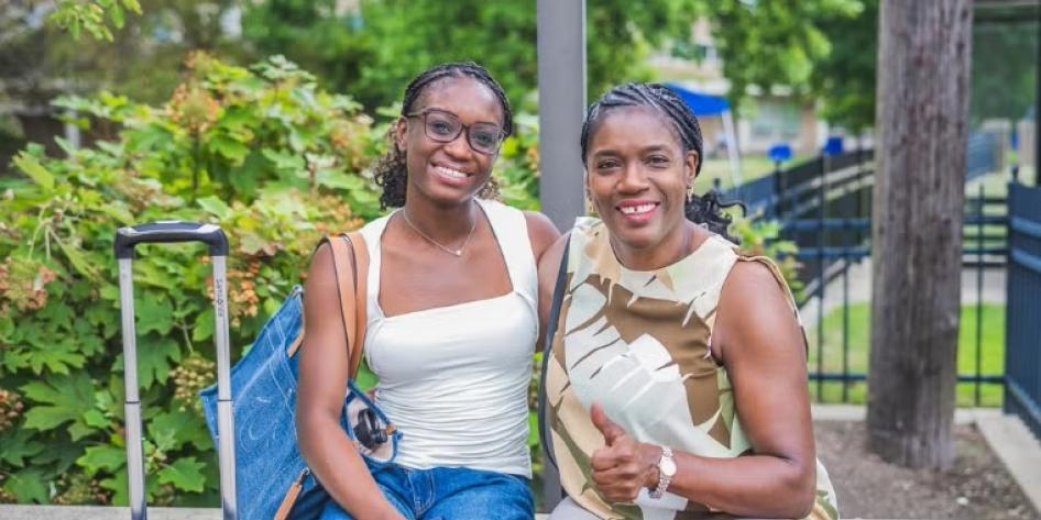 A CWRU student poses with a family member during move-in on Aug. 17.
