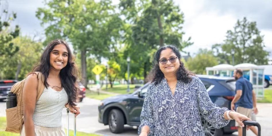 A CWRU student and their family member smile for a photo during move-in on Aug. 17.