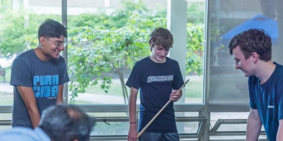 CWRU students and their families play pool on campus during move-in on Aug. 17.