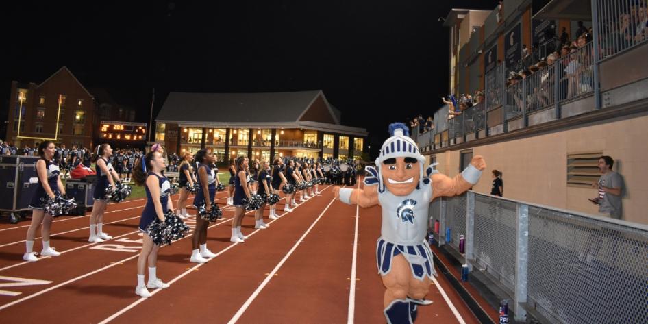 Spartie and cheerleaders show their CWRU spirit from the sidelines at a 2019 football game. 