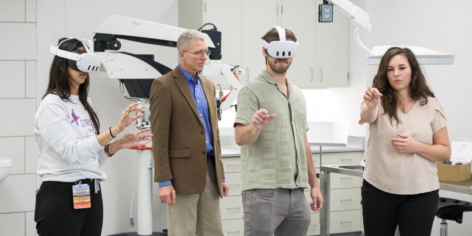 Four people using MetaQuest augmented reality devices