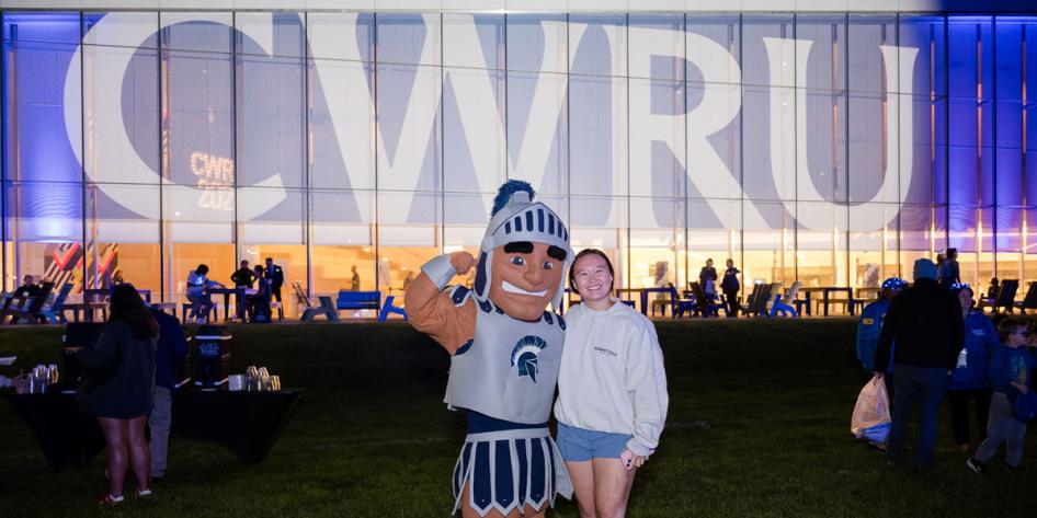 Spartie, CWRU's official mascot, poses with a CWRU community member at Homecoming and Reunion Weekend 2025's Blue Bash.