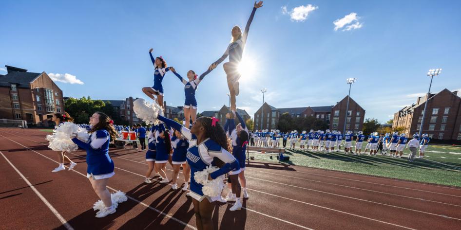 Spartan cheerleaders hit a stunt at the football game during Homecoming and Reunion Weekend 2025.