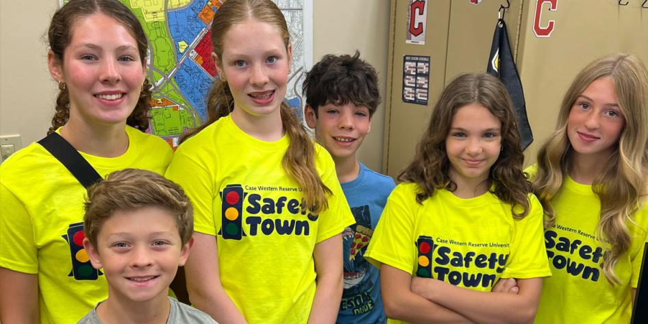 Photo of teenagers wearing neon Safety Town T-shirts