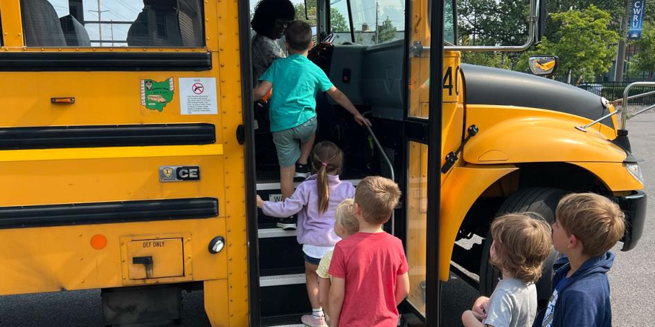 Photo of young children boarding a school bus