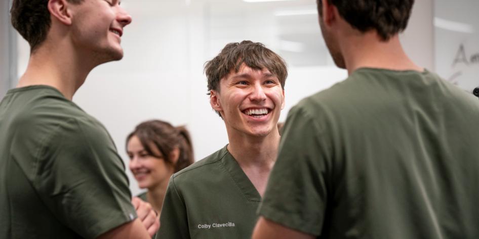 Three first-year dental students laugh together.