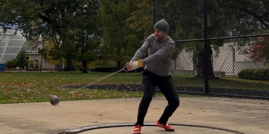 Joseph DeLong participates in a hammer throw track and field event. 
