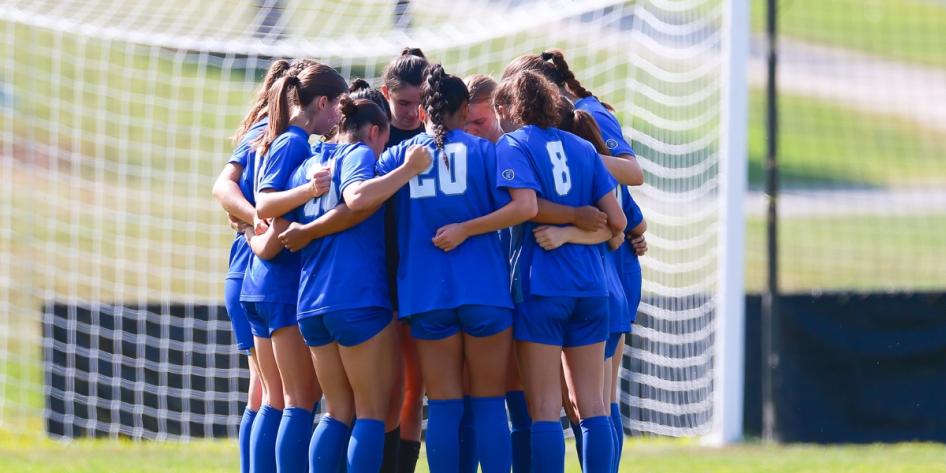 Jamie Goldfarb joins a group hug with soccer teammates. 