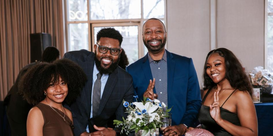 Joy Hendrix (pictured left) poses for a group photo at the Office of Multicultural Affairs' 2025 Unity Banquet. 