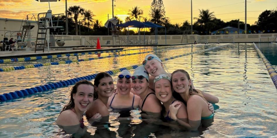 Claire Kozma and teammates in swimming pool. 