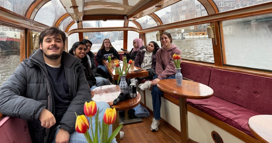 Students of the “Spring Break in The Hague" program ride in a boat. 