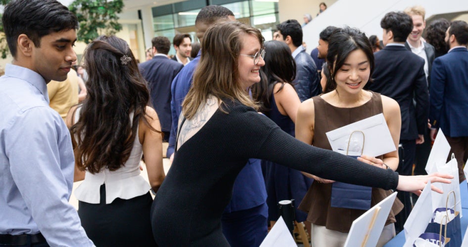 students grabbing bags with their match day envelopes