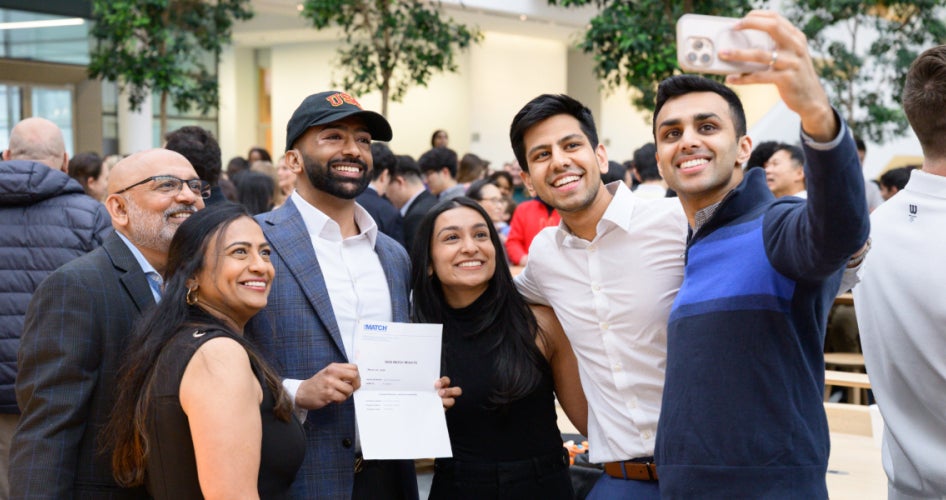 medical student posing for a selfie with their family