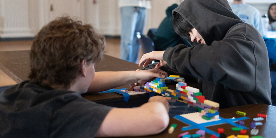 Image of students building a bridge out of legos