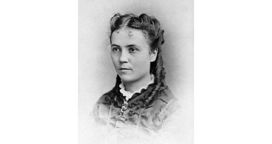 Portrait of a woman from the 19th century with braided hair and a lace collar. She appears poised and thoughtful against a soft, light background.