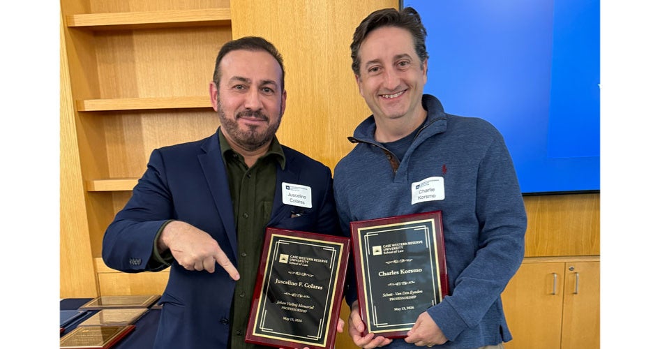 Juscelino Corales and Charles Korsmo holding plaques
