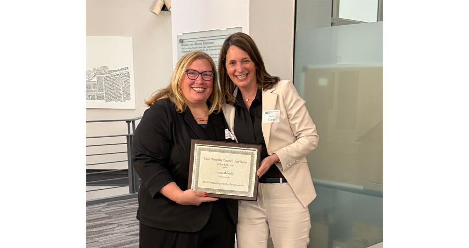 Laura McNally and Jenn Cupar holding a plaque