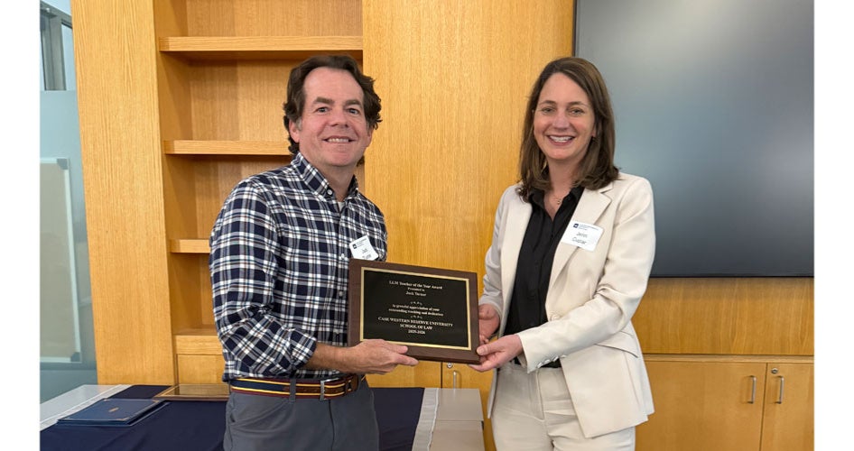 Jack Turner holding a plaque with Jenn Cupar