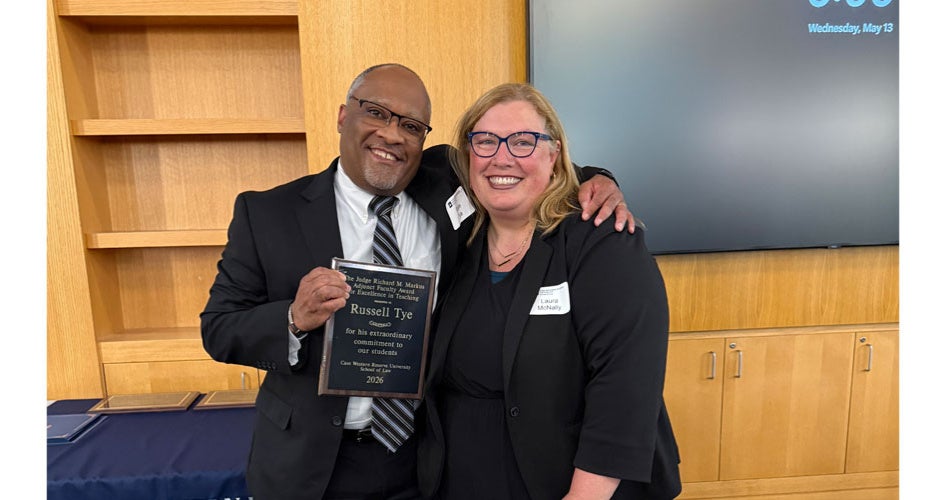 Russ Tye holding a plaque with Laura McNally
