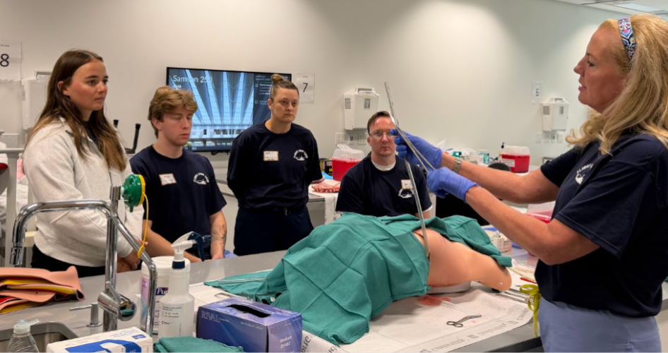 Jennifer Adamski demonstrates procedures to a group of students.