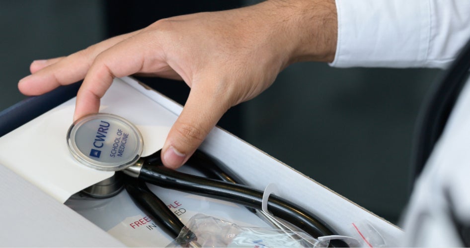 a hand holding a stethoscope