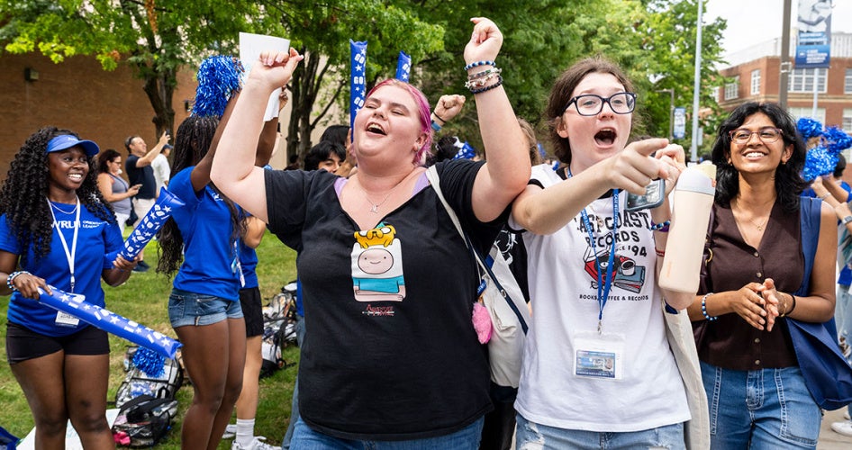 Two new CWRU students cheer as they participate in the clap-in