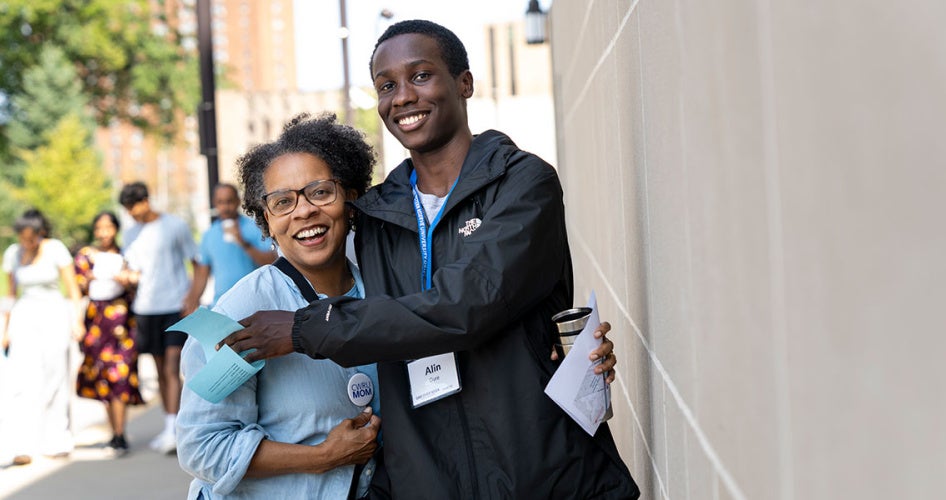 new CWRU student and his mom pose for a photo with their arms around one another