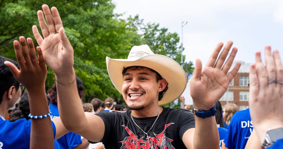 A new CWRU student holds his hands up to clap hands with others during clap in