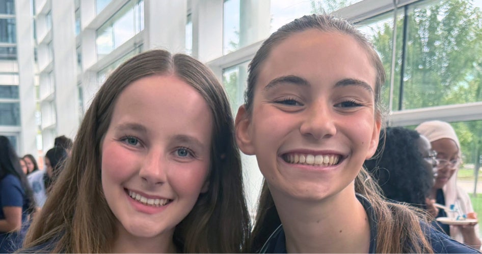 Two students smile after the stethoscope ceremony