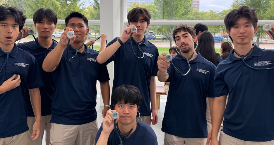 Students hold up their stethescopes