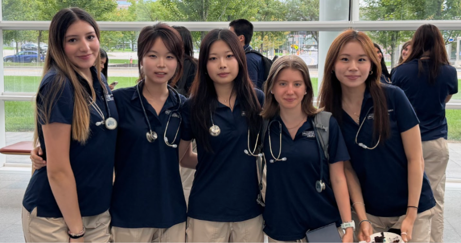 Five students smile after the stethoscope ceremony.