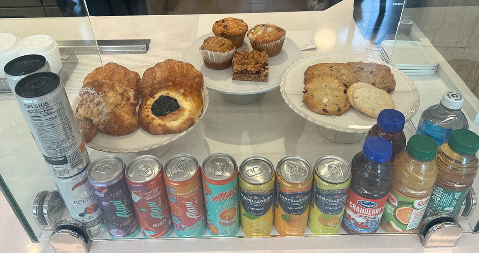 A lineup of beverages and bakery items on display behind glass at the counter in Tomlinson Hall