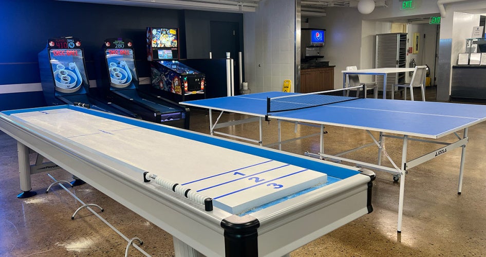 Photo of tabletop shuffleboard and a ping pong table in Knight Bytes