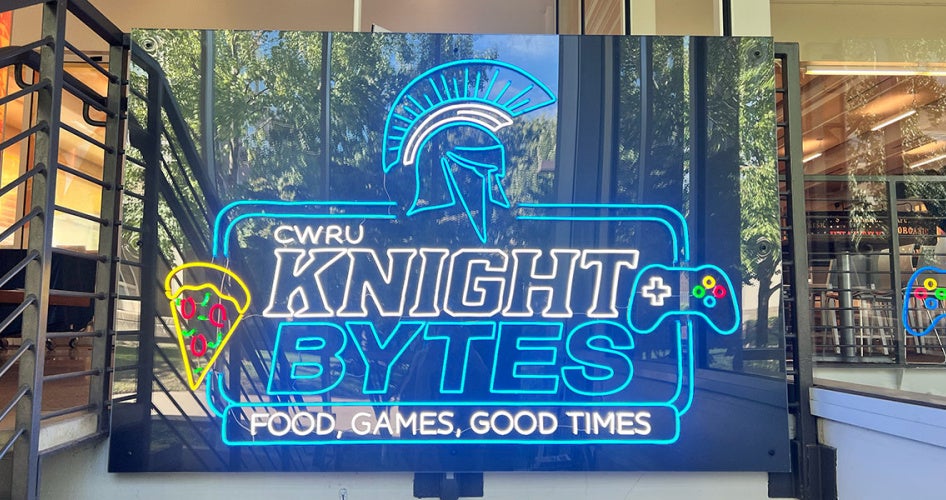 Photo of an illuminated neon sign that says "Knight Bytes" and "Food, Games, Good Times"