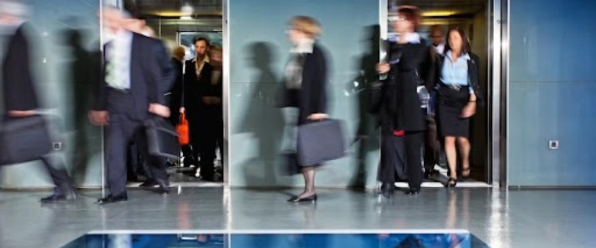 Business people walking through office.