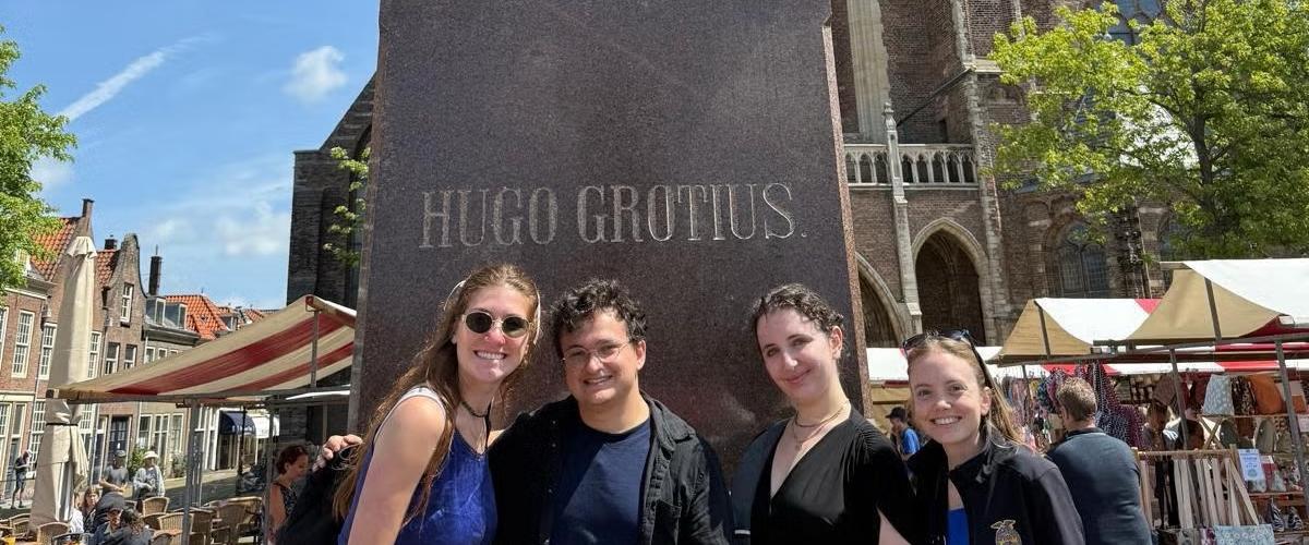 Standing in front of the famed Statute of Hugo Grotius, the Father of International Law, in The Netherlands, from Left to right: Kaylara Benfield, Oliber Bates, Teresa Lebowitz and Maria Blough