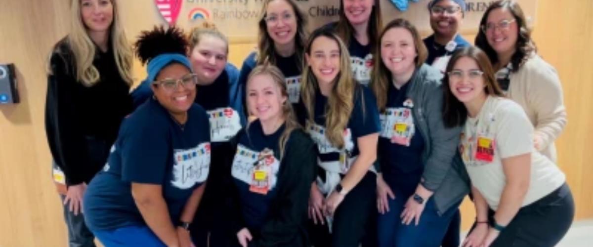 Cristin Coleman and other founding members of UH Rainbow Babies & Children’s Hospital's pediatric cardiac intensive care unit pose for a group photo.  