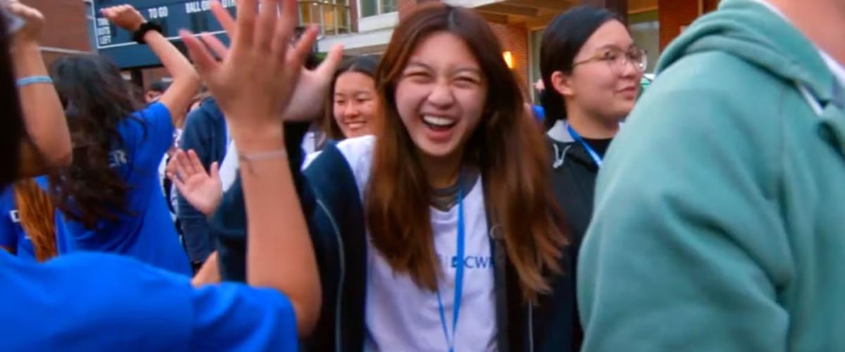 Student laughing in a crowd