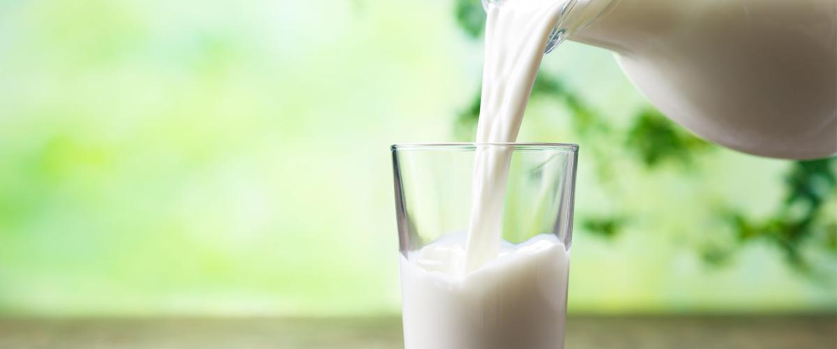 Photo of a pitcher of milk being poured into a glass