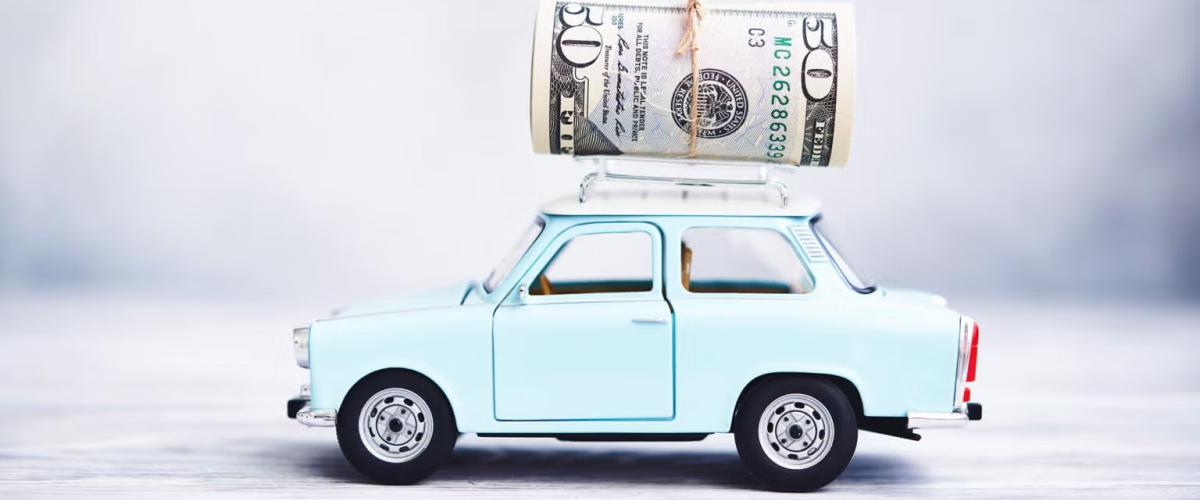 Small blue car with money on top