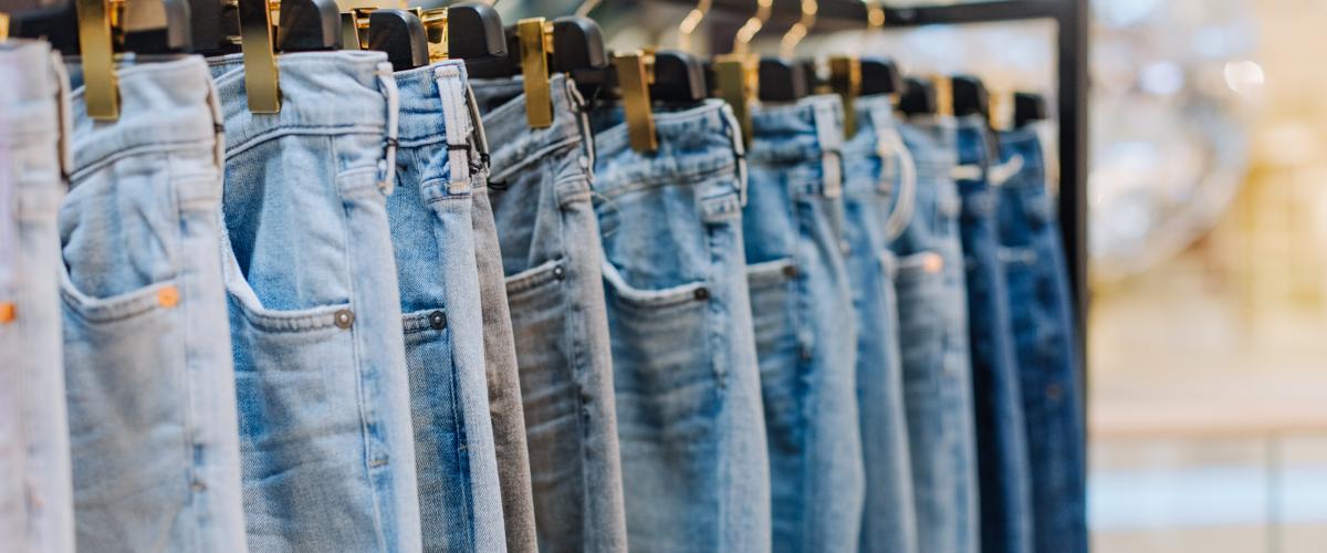 Denim jeans on a rack in a storefront