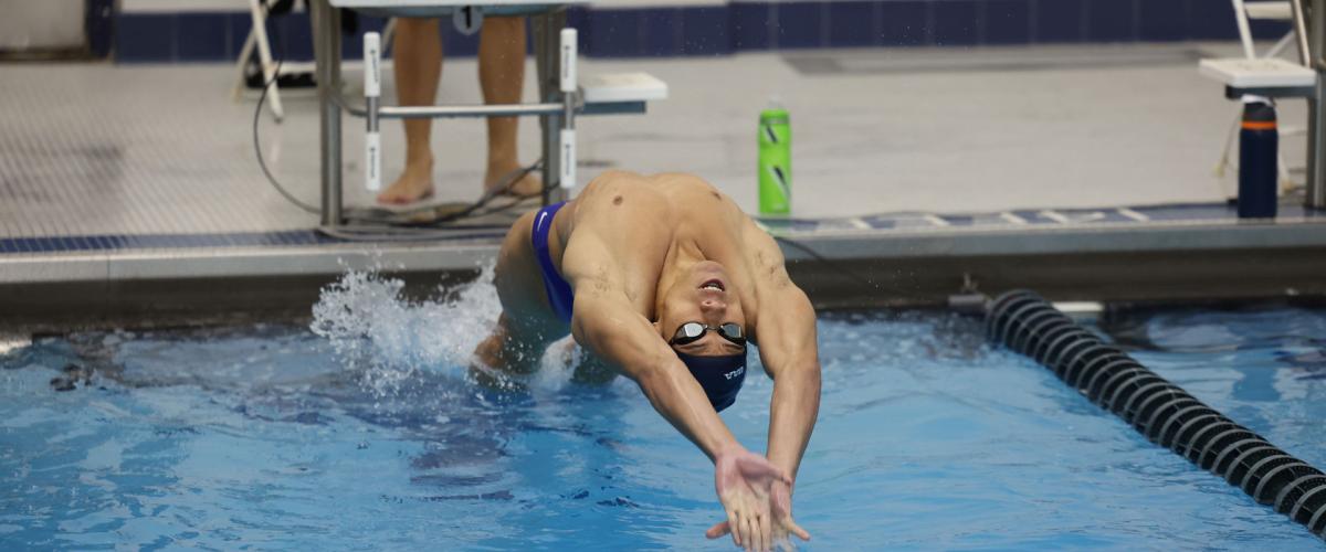 Case Western Reserve University swimmer Emil LaSida does a backstroke start