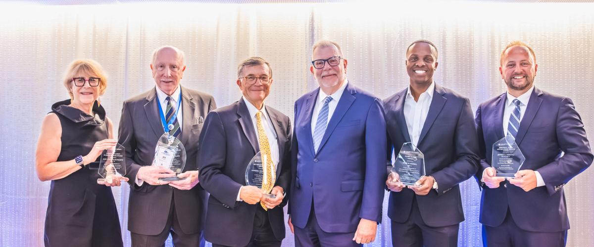 Five Case Western Reserve University alumni award winners pose with President Eric W. Kaler