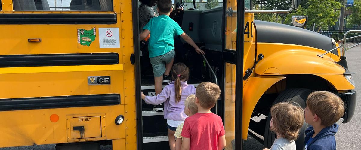 Photo of young children boarding a school bus