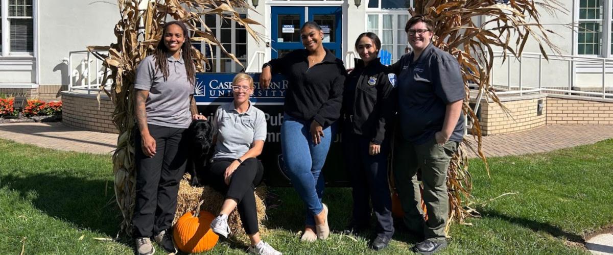 Members of the Division of Public Safety's Sexual Assault Response Team pose with a dog.