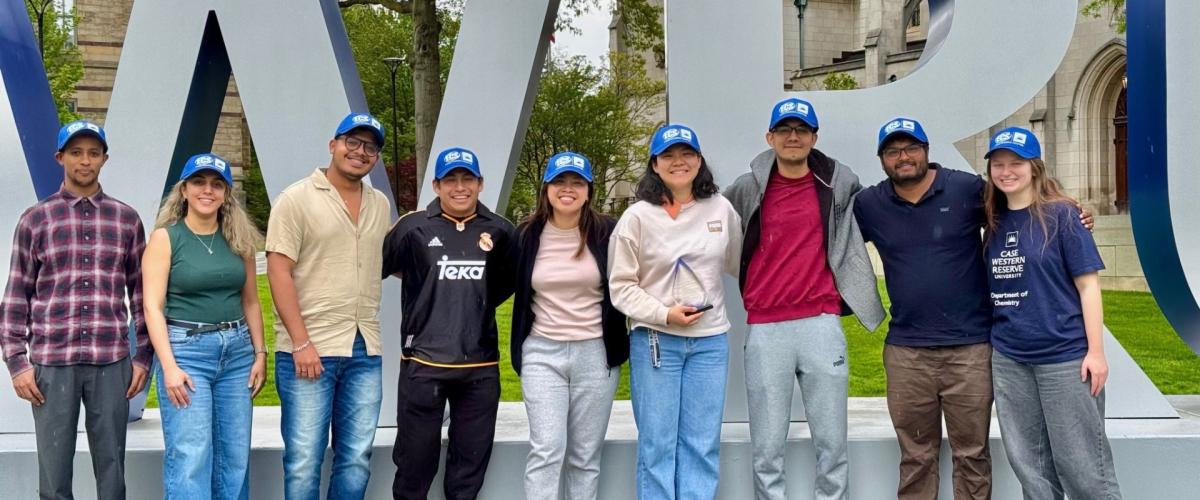 Members of The Electrochemical Society pose in front of CWRU letters. 