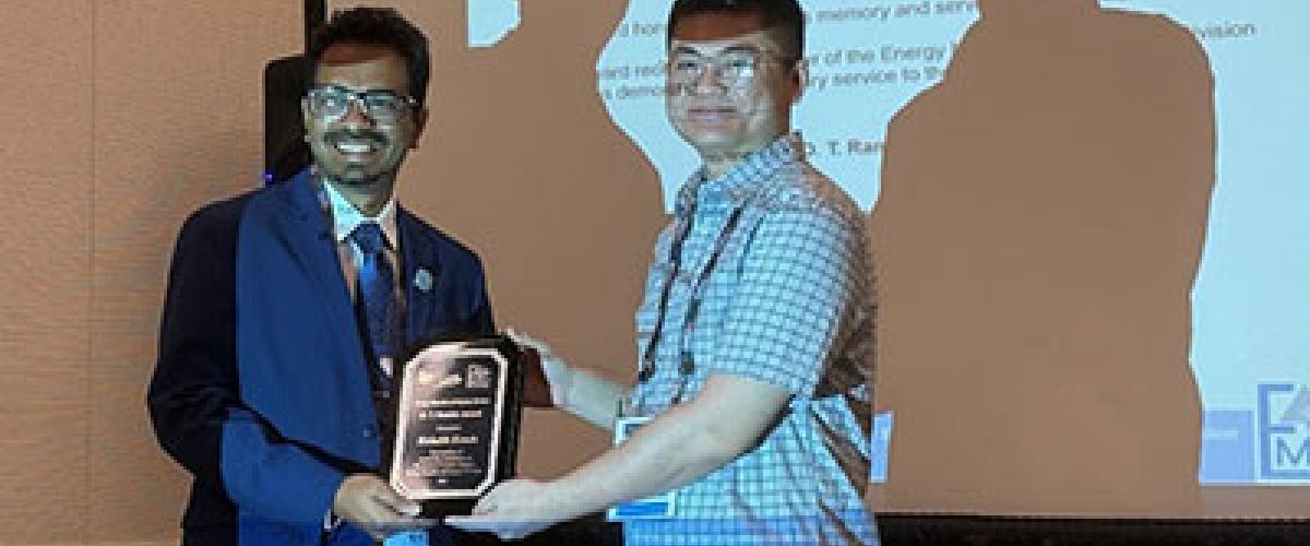 Photo of Rishab Kundu receiving an award