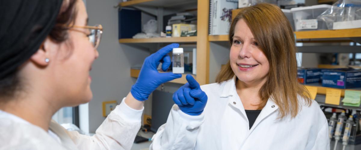 Agata Exner looking at materials in a lab with a student